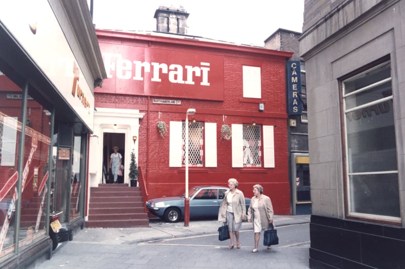  A view of Northumberland Court Newcastle upon Tyne taken in 1984. In the foreground to the left is 'Turners' photographic shop and to the right the side wall of the Blackett Street Post Office. 'Ferrari' clothes shop adjoins 'Turner's'. 