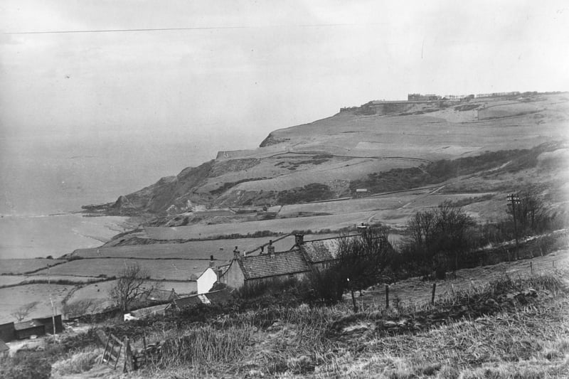 The rugged coastline between Robin Hood's Bay and Ravenscar in April 1949. The building near the cliff edge at top of the picture is the Raven Hall Hotel.