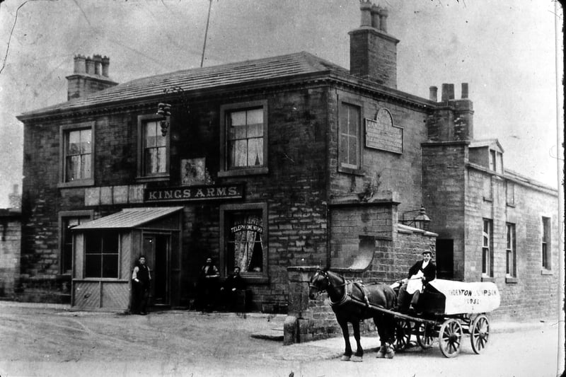 the Kings Arms pub at Gildersome Crossroads, with Street Lane on the right and Adwalton Lane (now Wakefield Road) to the left. The landlord at the time was James Hardy. In the window the words "Telephone no 99" can be seen. Three men are by the door while another is sitting on a horse-drawn cart to the side. The pub was still there in 1967 but was later demolished as the crossroads were extended to form a roundabout as part of the new road system to incorporate the M62 motorway. 