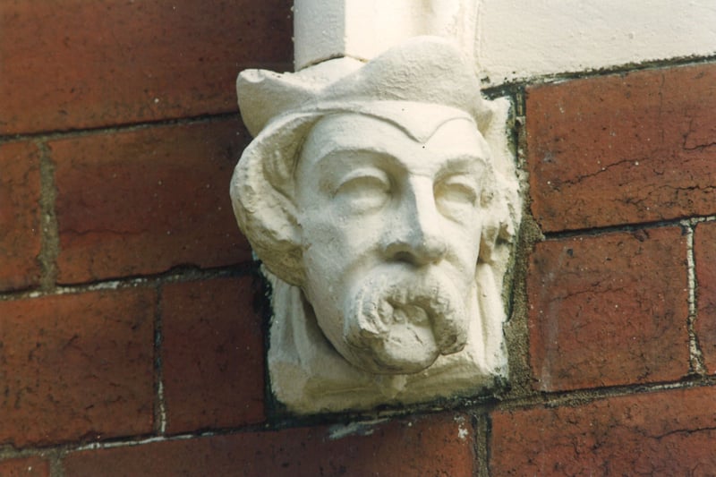 Close up of a carved head at the bottom of archways over front doors on Quarry Street. Pictured in August 1993.