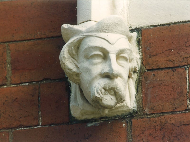 Close up of a carved head at the bottom of archways over front doors on Quarry Street. Pictured in August 1993.