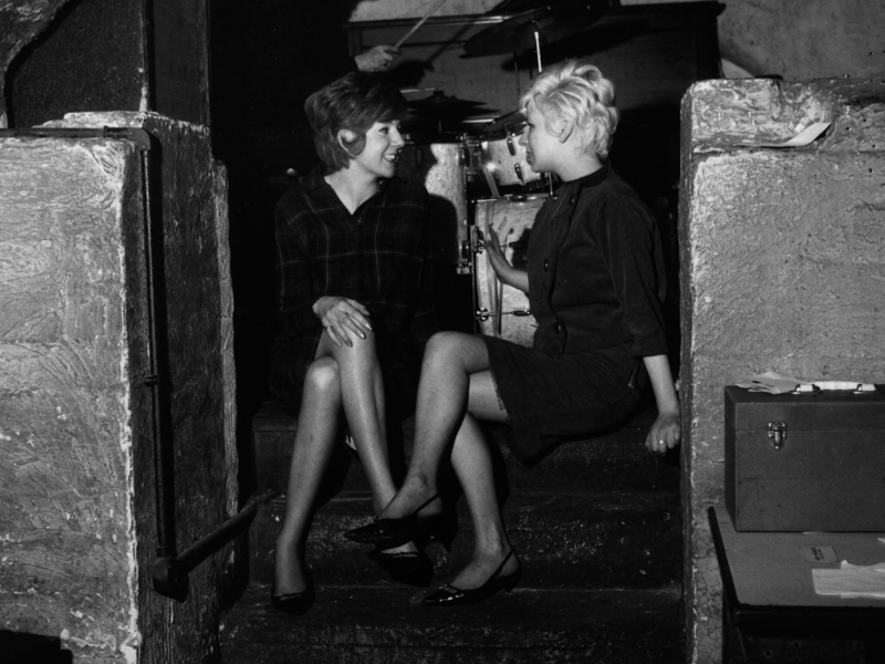 Liverpool's much-loved Cilla Black talking to a friend at The Cavern Club in 1963. The Cavern was the top destination for a night out.