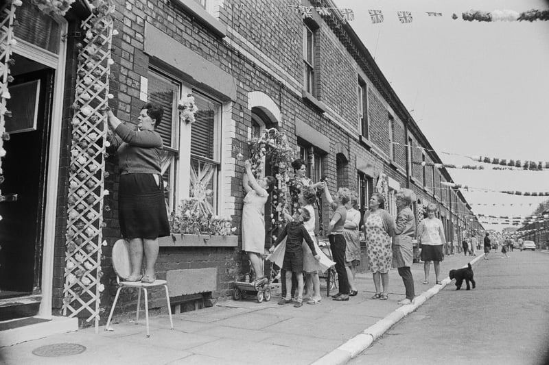 Irene Hughes and other residents of Claudia Street add the finishing touches to their decorations in preparation for the match between Bulgaria and Brazil at the nearby Goodison Park football ground during the 1966 World Cup, July 13, 1966. 
