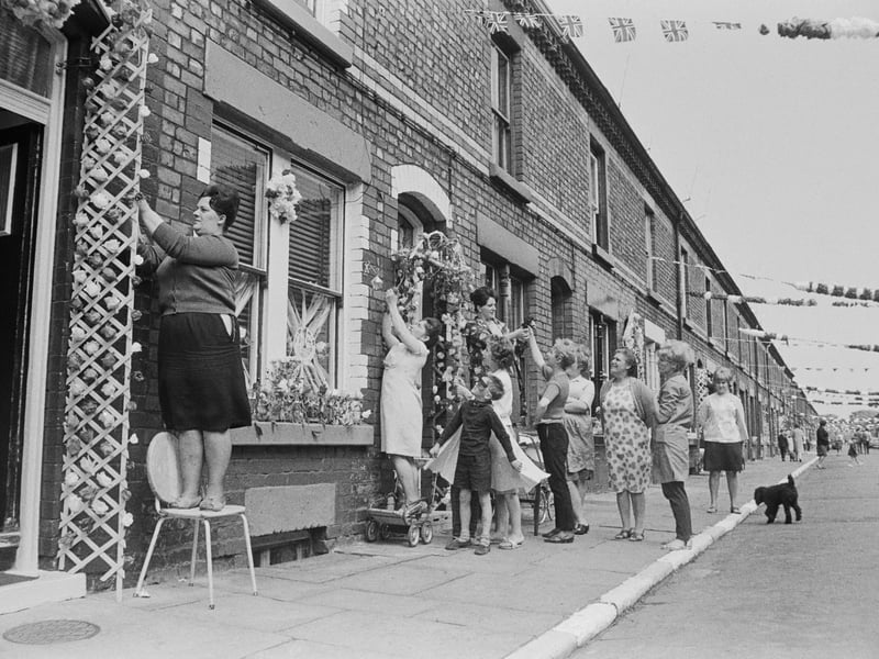 Irene Hughes and other residents of Claudia Street add the finishing touches to their decorations in preparation for the match between Bulgaria and Brazil at the nearby Goodison Park football ground during the 1966 World Cup, July 13, 1966.