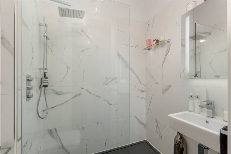 The luxury shower room has also been fitted with modern contemporary suites, walk-in shower units with glazed panels, rainwater shower heads, vanity furniture complimented by the use of Travertine floor and wall tiles.