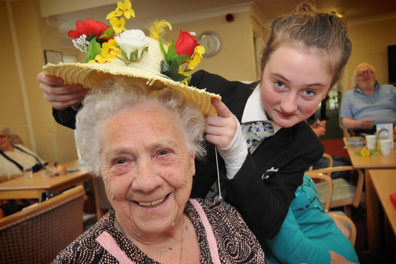Amy Scott, 12, helped Doris Collinson, 85, try out an Easter bonnet during a visit by pupils from Castle View Academy to St Margaret's Court Care Home in 2013. 