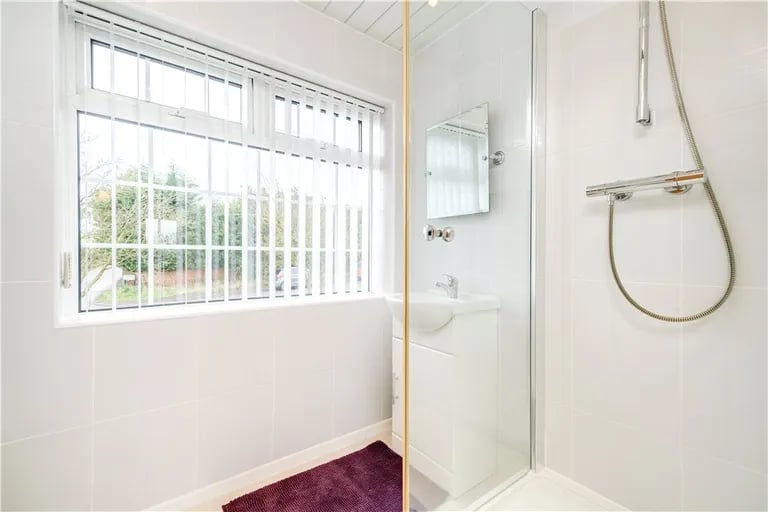 While a walk-in shower can be found in a separate shower room.