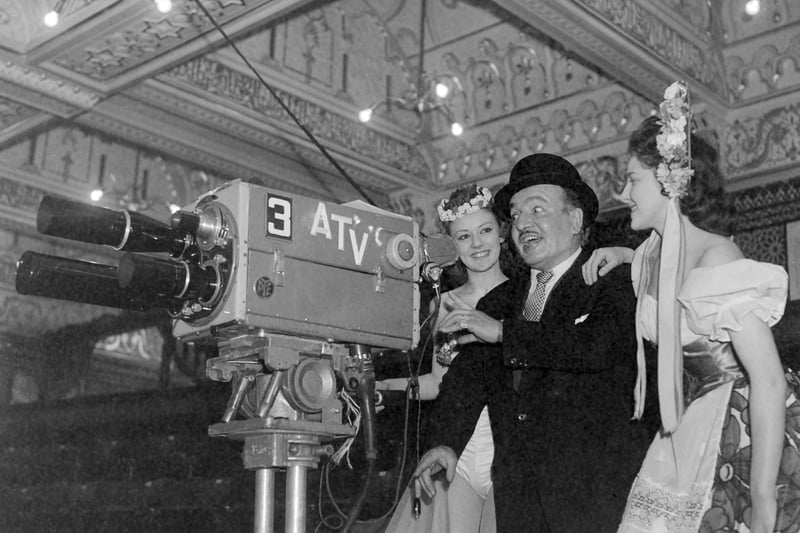 Tower circus clown Charlie Cairoli demonstrates his skill with the camera to Circusettes Sandra Edwards (left) and Valerie Sutton before the ITV broadcast of excerpts from the season show