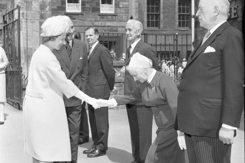 The Queen meets the nursing staff when she visits Edinburgh's Queensberry House Hospital - now part of the Scottish Parliament - in July 1965.