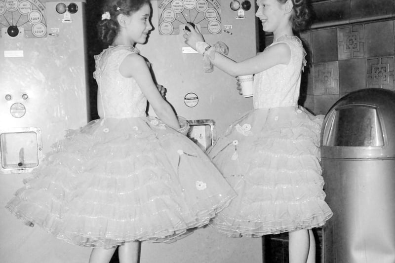 Two thirsty competitors at the Blackpool Dance Festival for Juniors at the Empress Ballroom try out the drinks machine
