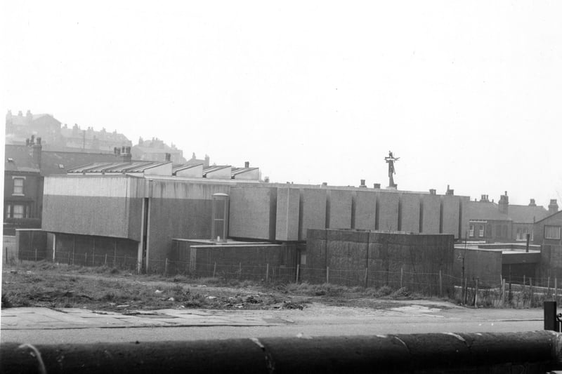 Sacred Heart R C Church on Woodsley Road and Hyde Park Road. View show the rear of the church which is constructed from concrete. An 'abstract' style cross is visible on top of the building. Houses can be seen in the background. Wasteground in the foreground. Pictured in June 1967.