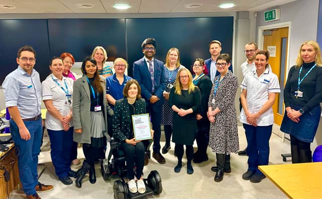 The neuromuscular team receive their national award with patient Kate
Woodcock-Fowles (front) and Rob Burley (5th from right) and Kirsten Major (4th
from right)