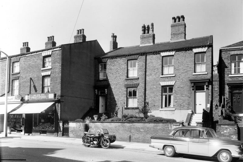 This view shows commercial and residential properties on Woodhouse Street in August 1961. On the left are numbers 224 and 222, a newagents run by A.W. and N. Spence and the Hyde Park Fruit Stores. Numbers 220 and 218 follow to the right with the doorway of number 216 just visible on the right edge.