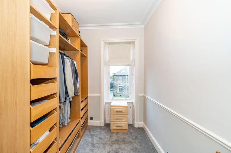 The front-facing fourth bedroom with fitted storage, is currently used as a dressing room.