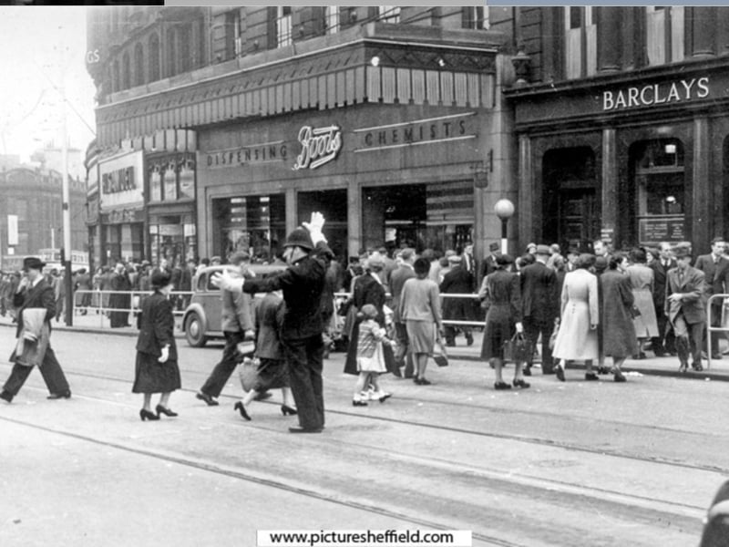 A policeman on High Street  directing pedestrians in 1952. Photo: Picture Sheffield