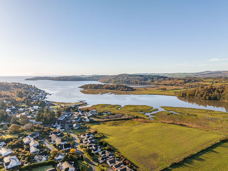 This five-bedroom
detached family home and two smaller rented dwellings in an enviable position with views over the Urr Estuary.