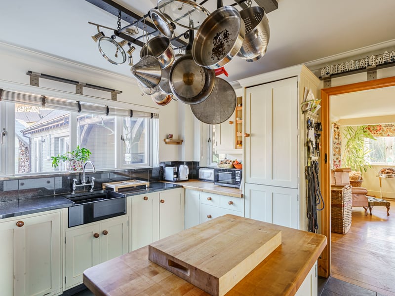 A country-style kitchen benefits from an island and in-set sink.
