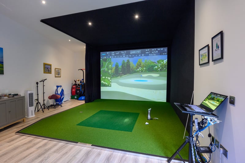 A quirky timber-built golf studio can be found in the garden to the rear of the property.