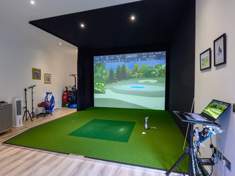 A quirky timber-built golf studio can be found in the garden to the rear of the property.