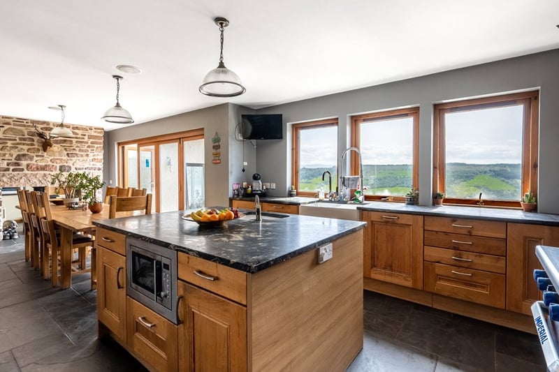 Bi-folding doors in the open-plan kitchen dining room open to a patio area, which is the ideal spot for taking in the Loch Ness panoramas.