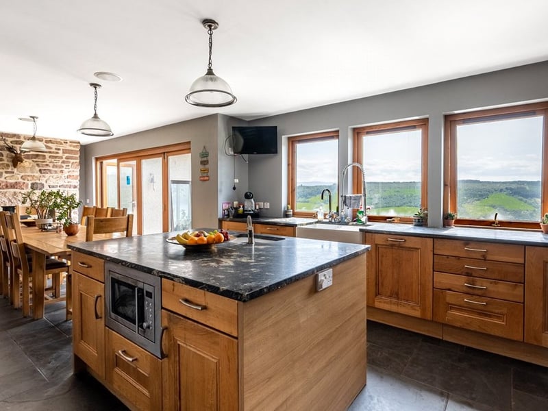 Bi-folding doors in the open-plan kitchen dining room open to a patio area, which is the ideal spot for taking in the Loch Ness panoramas.