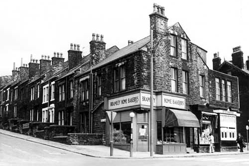 Hough Lane at the corner with Stanningley Road in March 1973. Number 272, is the Bramley Home Bakeries Limited. The middle shop, at number 270, is a confectionery and tobacco store run by Reginald Deamer. On the far right, at number 268, is a shop called Windsor's at the corner with Ashdown Street.