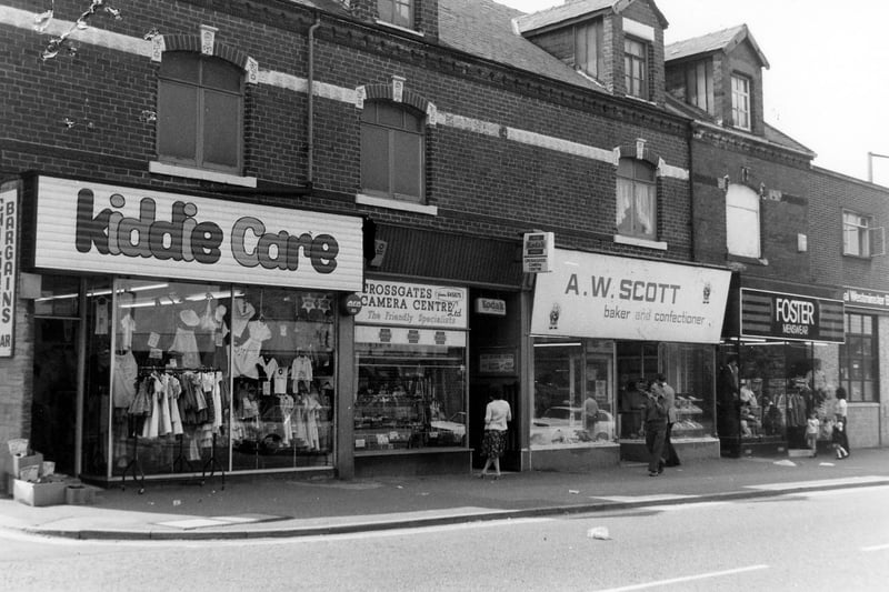 A parade of shops on Austhorpe Road, showing, from left, No.8 Kiddie Care children's wear, No.6 Crossgates camera centre, No.4. A.W.Scott, baker and confectioner and No.2 Foster menswear. On the far right the National Westminster Bank can just be seen; this faces on to Station Road. Pictured in October 1980.