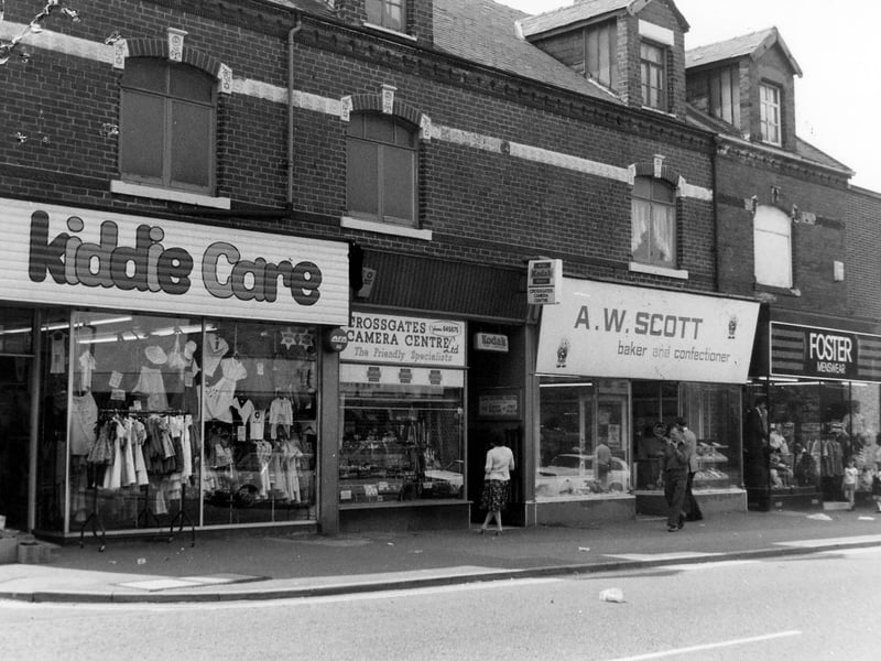A parade of shops on Austhorpe Road, showing, from left, No.8 Kiddie Care children's wear, No.6 Crossgates camera centre, No.4. A.W.Scott, baker and confectioner and No.2 Foster menswear. On the far right the National Westminster Bank can just be seen; this faces on to Station Road. Pictured in October 1980.