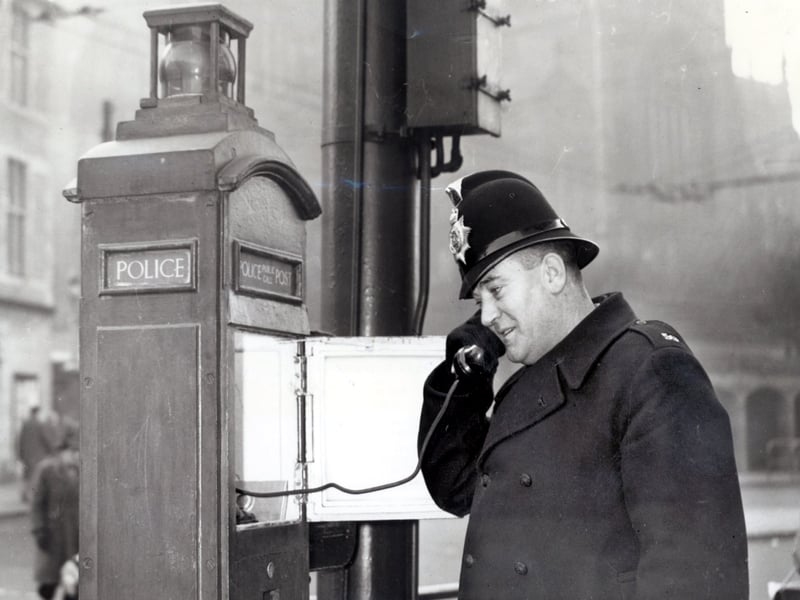 PC F Bradshaw making a call from the new police telephone pillar box in All Saints Square, Rotherham, January 3, 1957