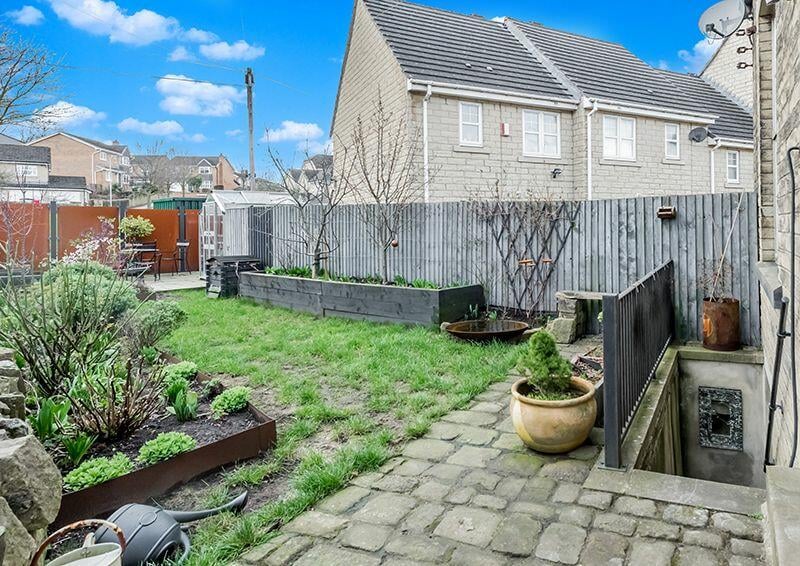 The garden features stone flagged patio, lawn and sleeper raised borders along with a greenhouse.