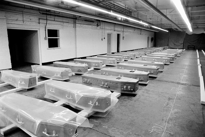 Coffins in a disused Liverpool warehouse waiting for gravediggers to end their strike before funerals can take place, December 1978. Image: Tom Stoddart/Getty Images