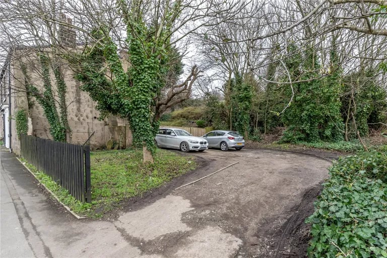 To the side of the property is a plot owned by the council where cars can be parked.