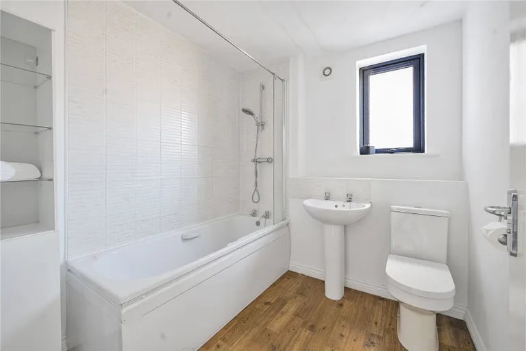 On the first floor is also the family bathroom with shower over bathtub.