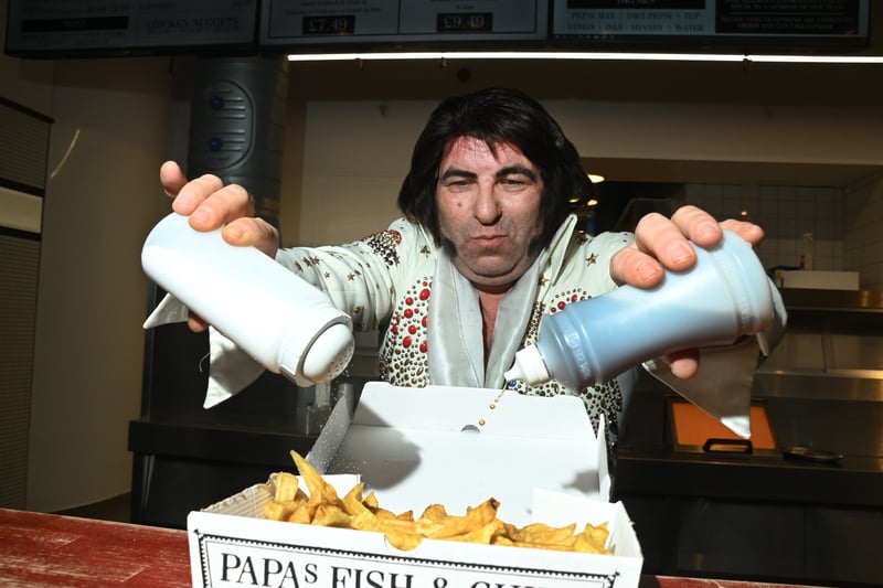 Elvis tribute, David Black, 53, from Essex, samples the local fish and chips ahead of the contest.