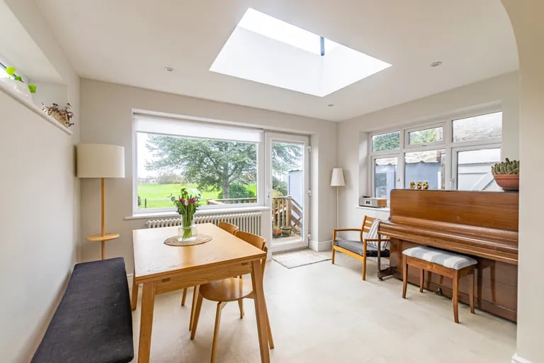 The dining room overlooks the rear garden and featuring a roof lantern for lots of natural light.