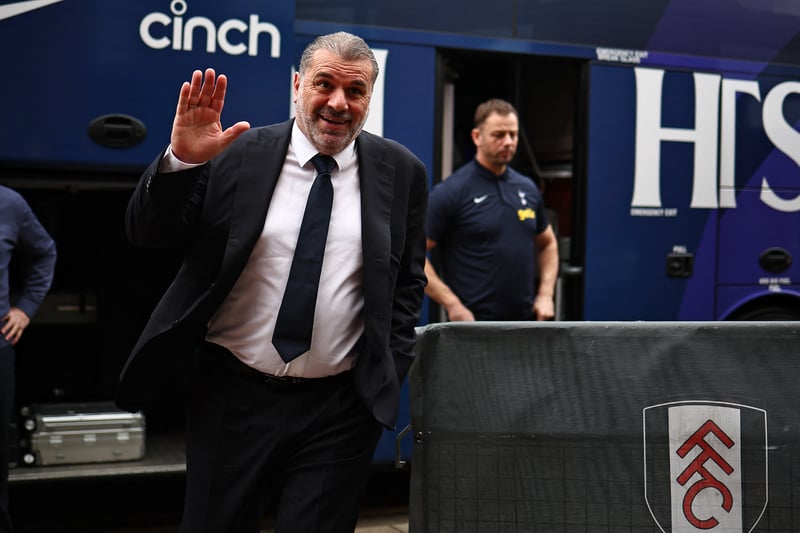 Spurs boss Ange Postecoglou greets fans as he gets off the bus.