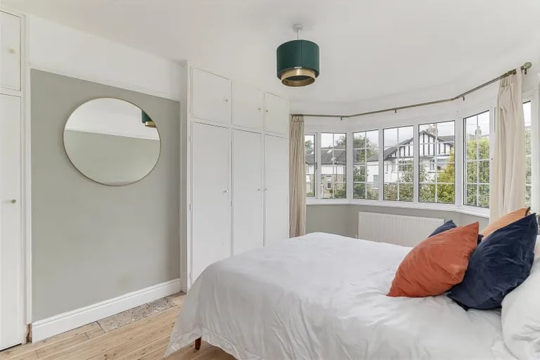 On the first floor is the master bedroom with built-in wardrobes and large bay window overlooking the front.