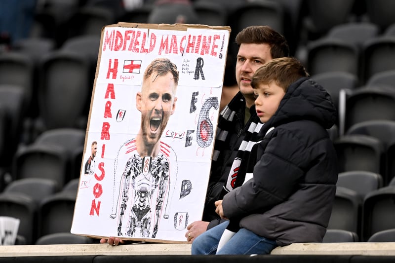 One young Fulham fan shows love to Harrison Reed.