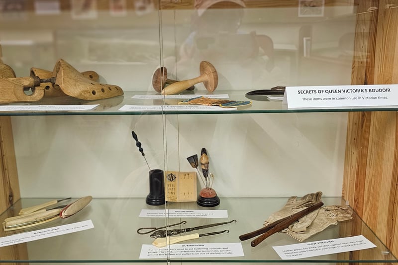 The display includes a collar box, a hot water bottle, swelling salts, manicure items and glove stretchers among other items commonly used in Victorian times.