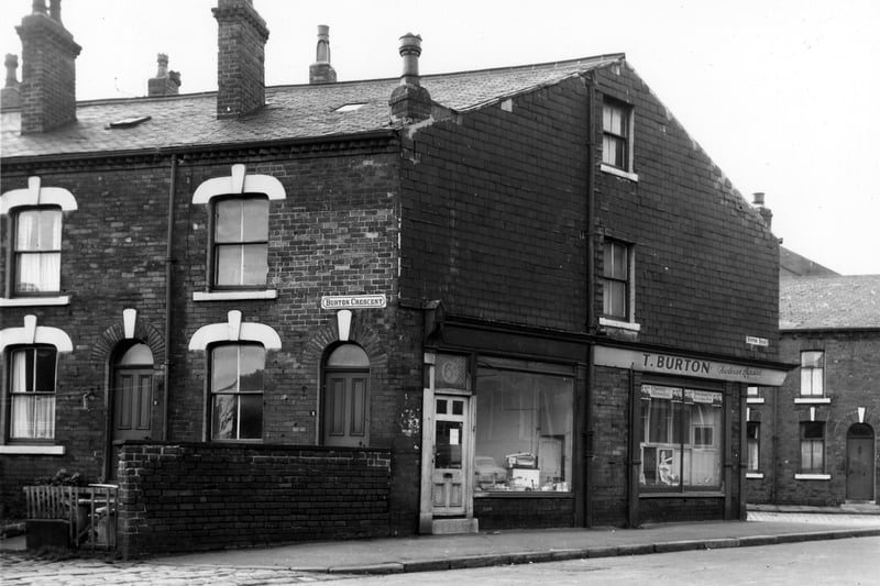 A view looking across Burton Road. Burton Crescent is to the left with numbers 3 then 1. This is the house at the corner with Burton Road and includes the adjacent shop premises numbered 6a Burton Road. To the right, 4 is a shoe repair shop, business of T. Burton. Burton Terrace is on the right. Pictured in October 1967.