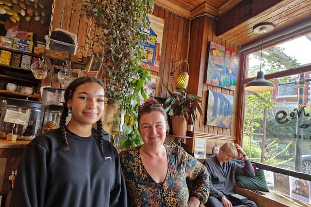 Jasmine Murphy and Jenny Rudd, pictured at Cafe 9, with works of art by local painters on the wall in the background. Picture: David Kessen, National World