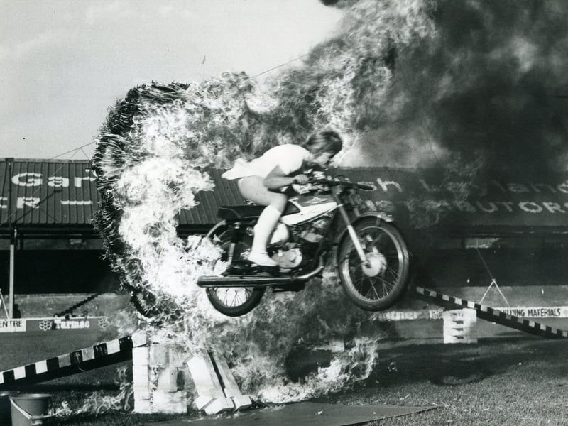 The Trabor Family Great Daredevil Circus at Blackpool Football Club, Bloomfield Road in 1975.
A member of the Moto Birds team crashing through a ring of fire at top speed