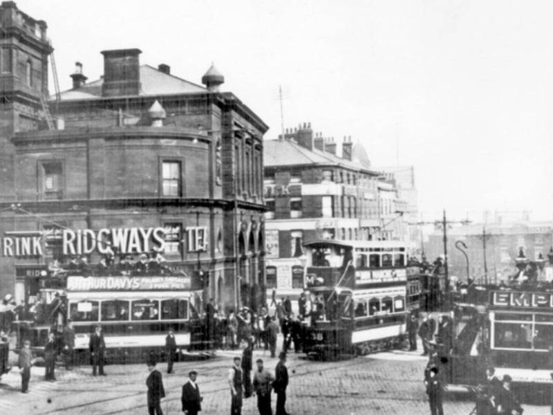 Fitzalan Square at the junction of High Street, Haymarket (background) and Commercial Street (right), with Fitzalan Chambers and Fitzalan Market Hall, including Stables and Co tea dealers, left, some time between 1900 and 1919