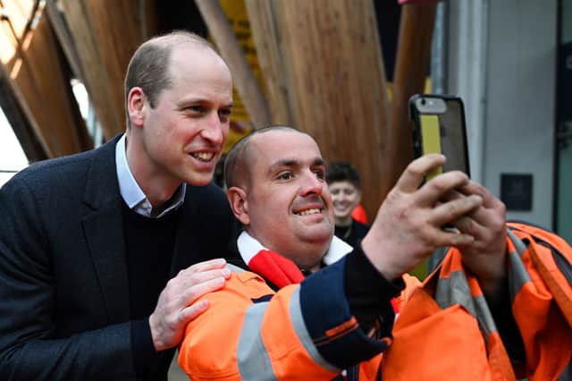 Prince William poses for pictures with Leigh Stinchcombe on his way to attend a Homewards Sheffield Local Coalition meeting, at the Millennium Gallery, in Sheffield, about how to tackle homelessness. The Prince of Wales even offered to hold Leigh's drinks cup so he could fish out his phone.
