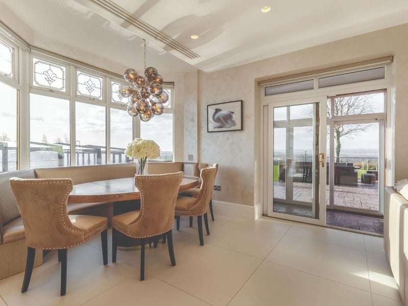An enormous bay window brings a whole lot of light into the kitchen, dining area and nearby sitting area.