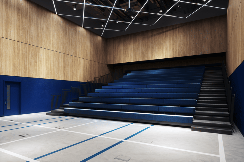 A versatile theatre / auditorium in The Social Hub Glasgow. It can be used to give presentations or other events that require a larger capacity than a meeting room. The seats can be folded into the wall so that the space can be used for sports, hence the lines on the floor of the space.