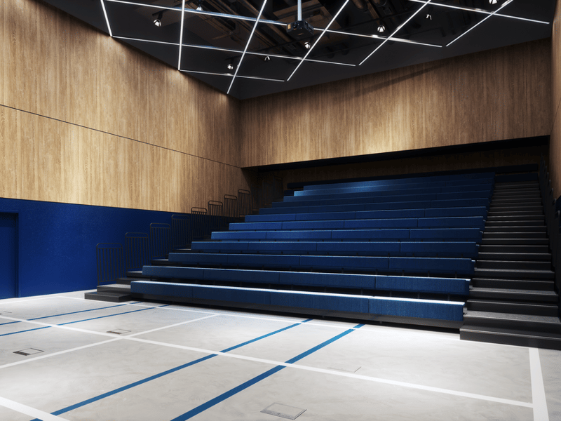 A versatile theatre / auditorium in The Social Hub Glasgow. It can be used to give presentations or other events that require a larger capacity than a meeting room. The seats can be folded into the wall so that the space can be used for sports, hence the lines on the floor of the space.