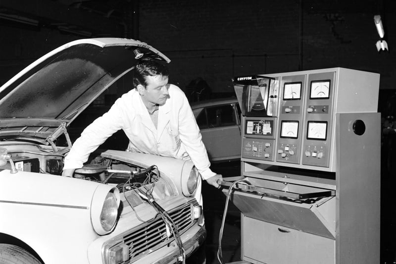 A mechanic working on a car in the James Ross garage at Lochrin Place in Edinburgh in October 1968.