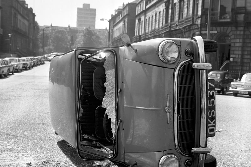 A Mini lies on its side after a collision at the junction of Melville Street and Walker Street in Edinburgh, June 1969.