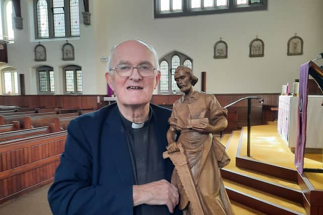 Fr William Kilgannon, with the St Joseph figure which is now back with the church. Photo: Pete Connor